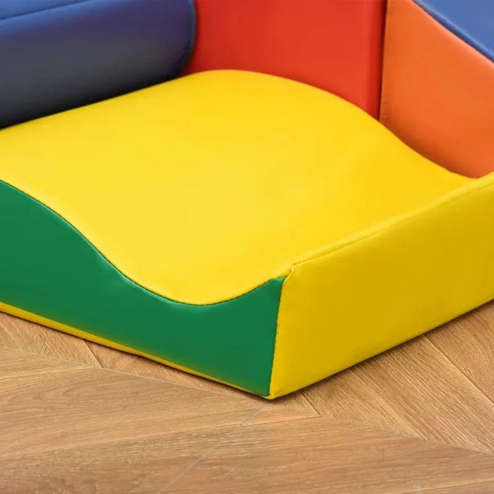 Colorful foam block set for kids on wooden floor, featuring yellow, green, red, and blue shapes.