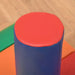 Colorful foam cylinder block with red top and blue sides on play mat