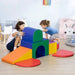 Kids playing on a 7-piece multi-coloured soft playset with geometric shapes indoors