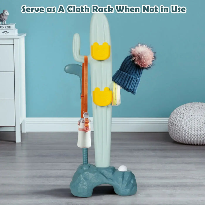 Cactus-shaped coat rack with a hat and jacket against a blue wall.