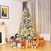 Decorated Christmas tree with lights and presents in a living room setting.