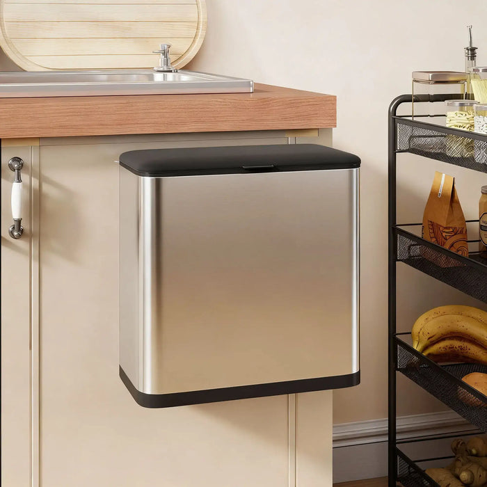 Silver trash can with black lid in a kitchen setting