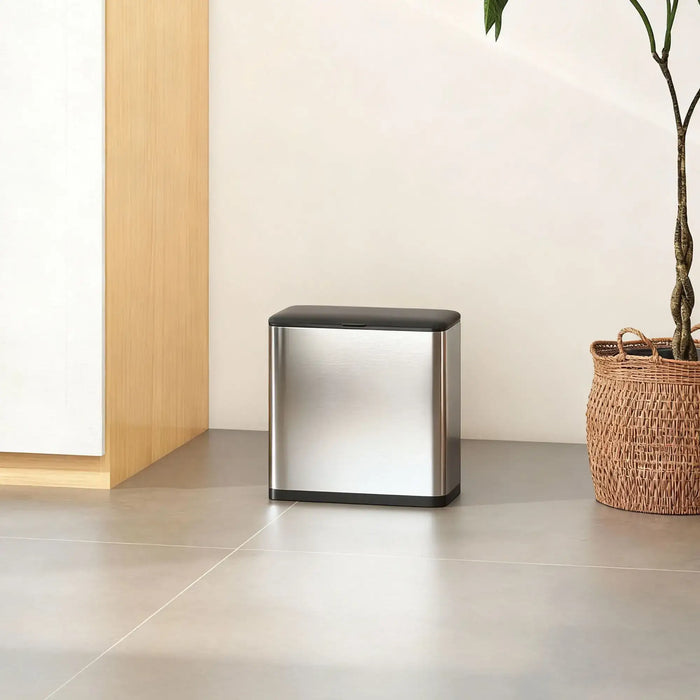 Modern metallic side table with black accents in a minimalistic room.