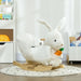 White plush rocking horse with rabbit design on a wooden base in a nursery setting.