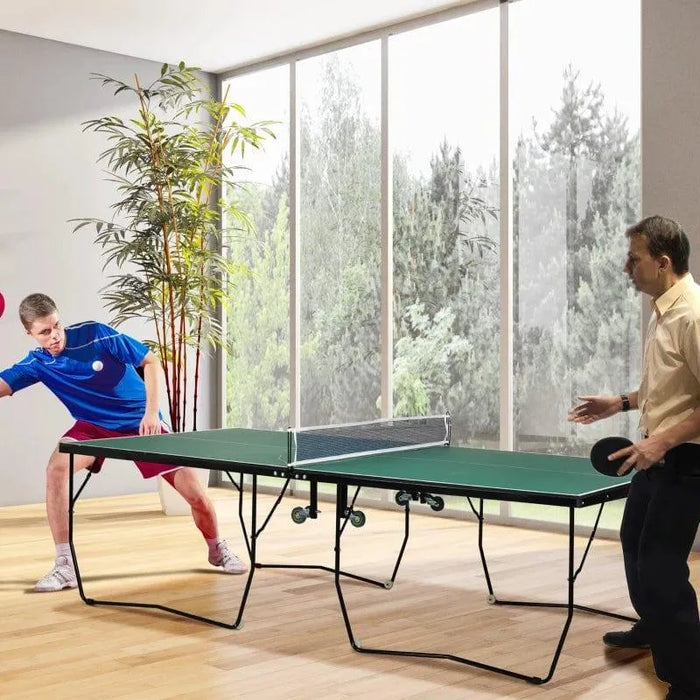 Two men playing table tennis on a green 9ft professional ping pong table indoors