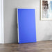 Folded blue table tennis table stored upright in a modern room with wood floor