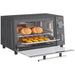 Toaster oven with bread and pastries on a white background
