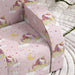 Pink unicorn and rainbow printed kids armchair on textured white rug