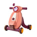 Toy scooter with pink body and purple handlebar on a white background