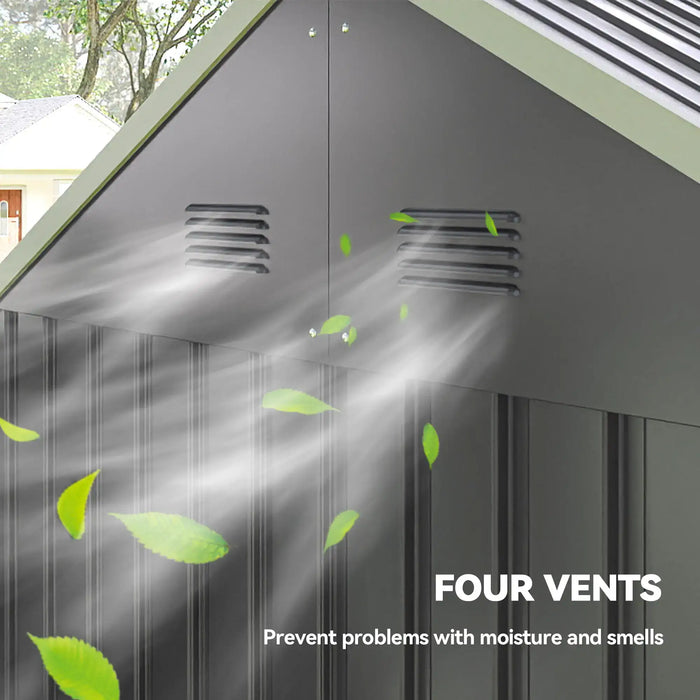 Four black vents on gray metal shed wall with airflow and green leaves illustrating ventilation
