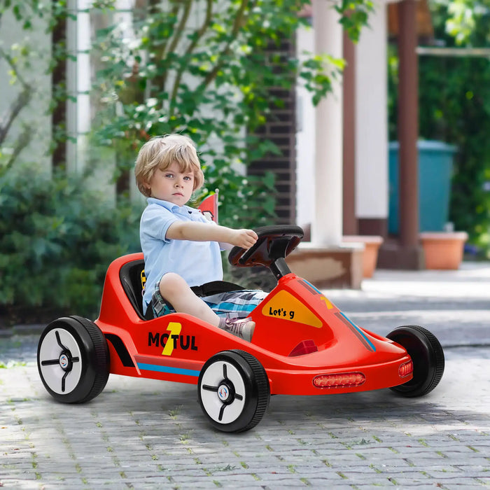 Child playing with a red toy car outdoors