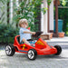 Child playing with a red toy car outdoors