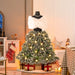 Mannequin dressed as Christmas tree skirt with lights and pine cones, white shawl, indoor holiday decor