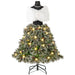 Christmas tree skirt with snow-frosted pine branches, pine cones, and warm white lights on mannequin