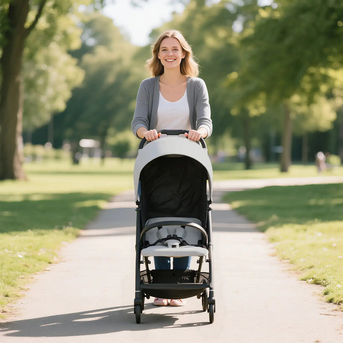Woman pushing a stroller in a park