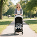 Woman pushing a stroller in a park