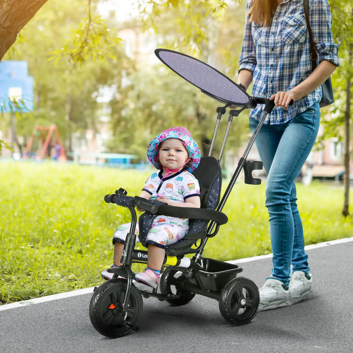 Child in a stroller being pushed by an adult on a path with greenery in the background