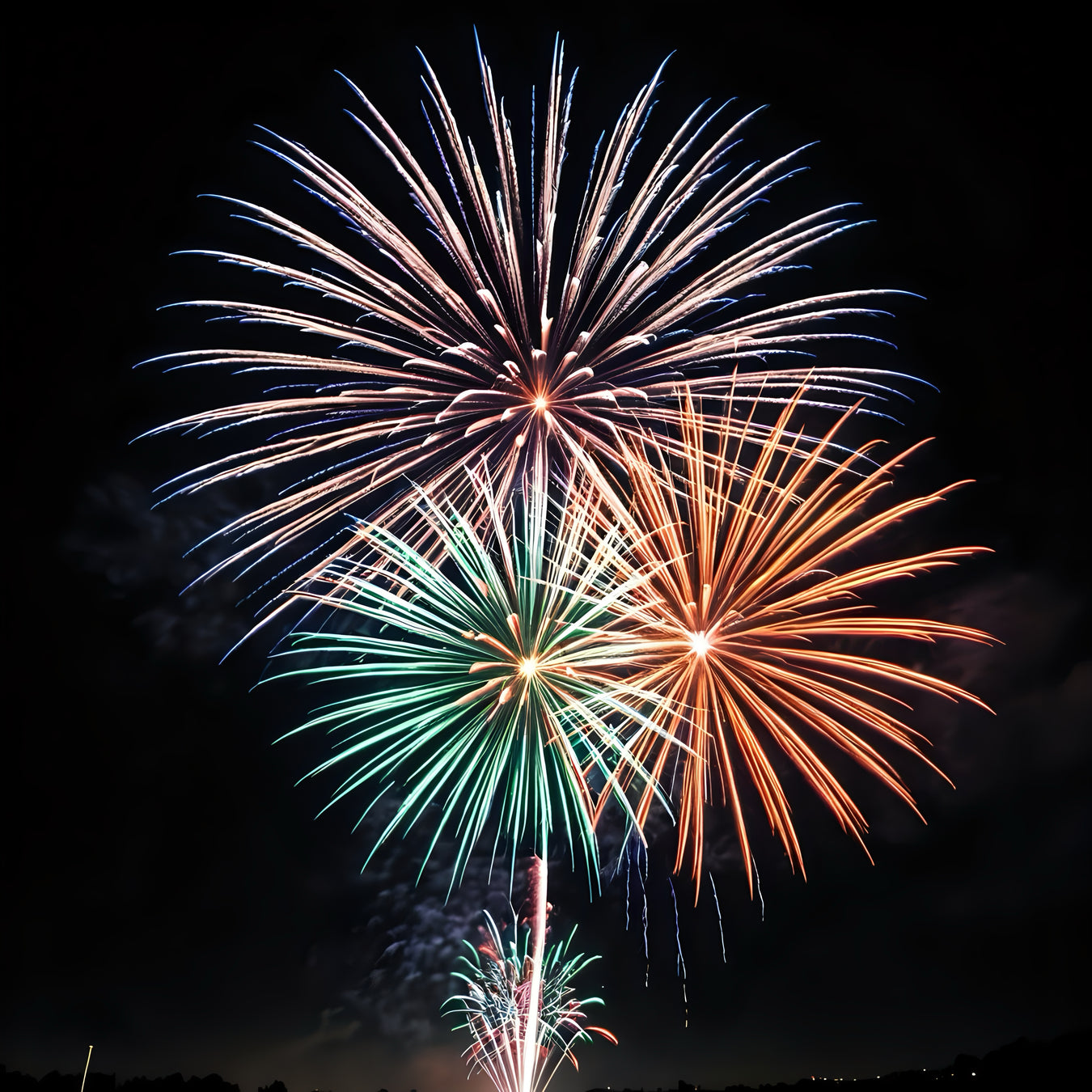 An image of fireworks in green, orange and red | Little and Giant Explorers