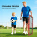Father and son in blue shirts on soccer field with foldable red rebound net and soccer ball