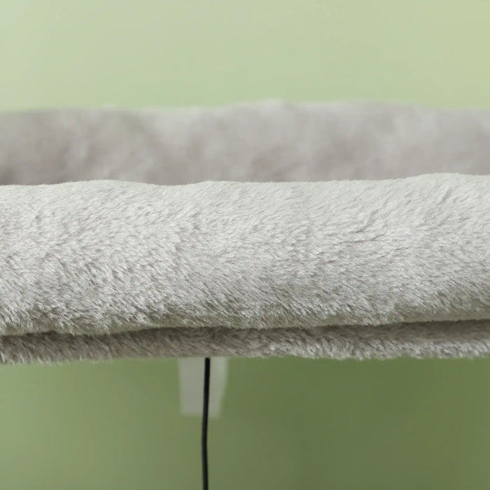 Soft gray plush pet bed with raised edges against a light green background