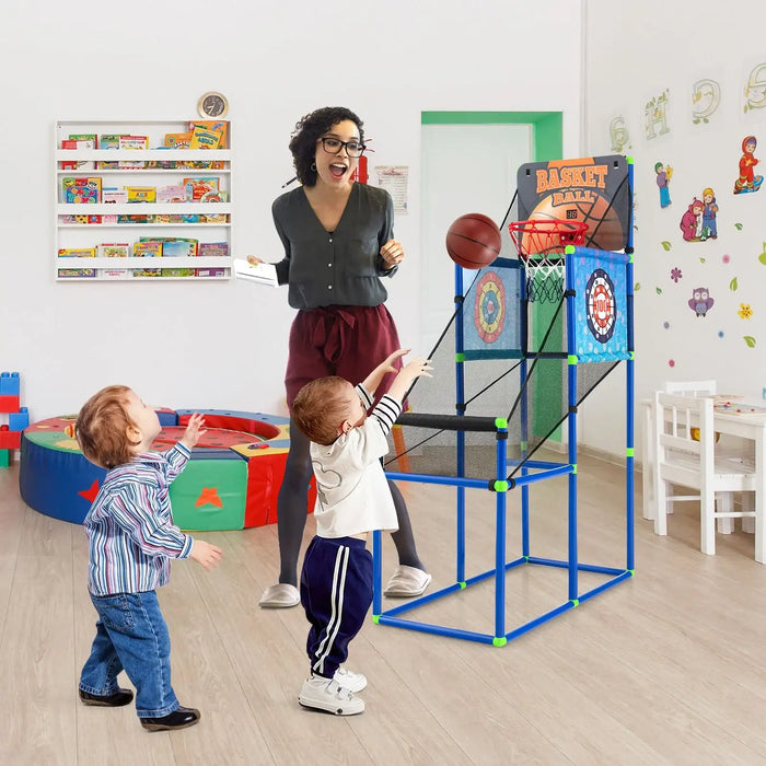 Teacher and children playing with a basketball hoop in a classroom setting.