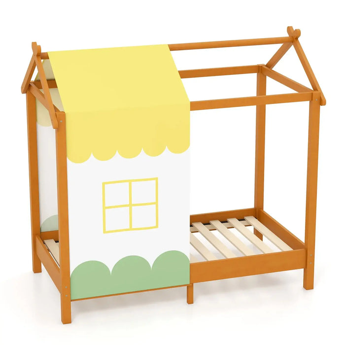 Children's bed with house design and yellow blanket on a white background