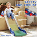 Toddler sliding down a blue and white indoor slide with safety zones labeled on a living room floor