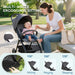 Woman and baby with a stroller in a park, highlighting multi-angle ergonomic sitting feature.