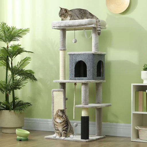 Two tabby cats on gray multi-level cat tree with scratching posts in cozy green room