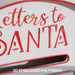 Close-up of white mailbox with red embossed text reading 'Letters to Santa' and a mail slot