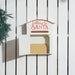 White wooden mailbox with red text "Letters to Santa" on white fence, containing a brown envelope