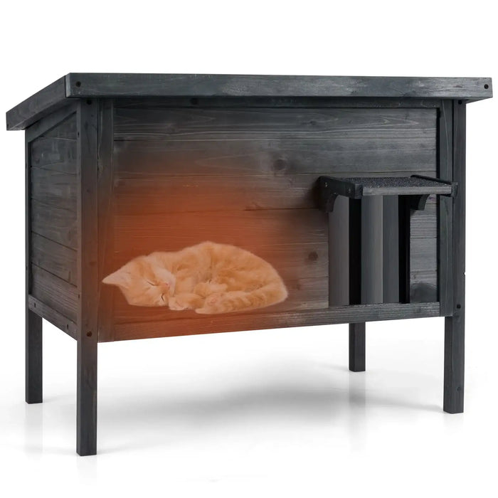 Outdoor insulated grey wooden cat house with a sleeping orange kitten inside