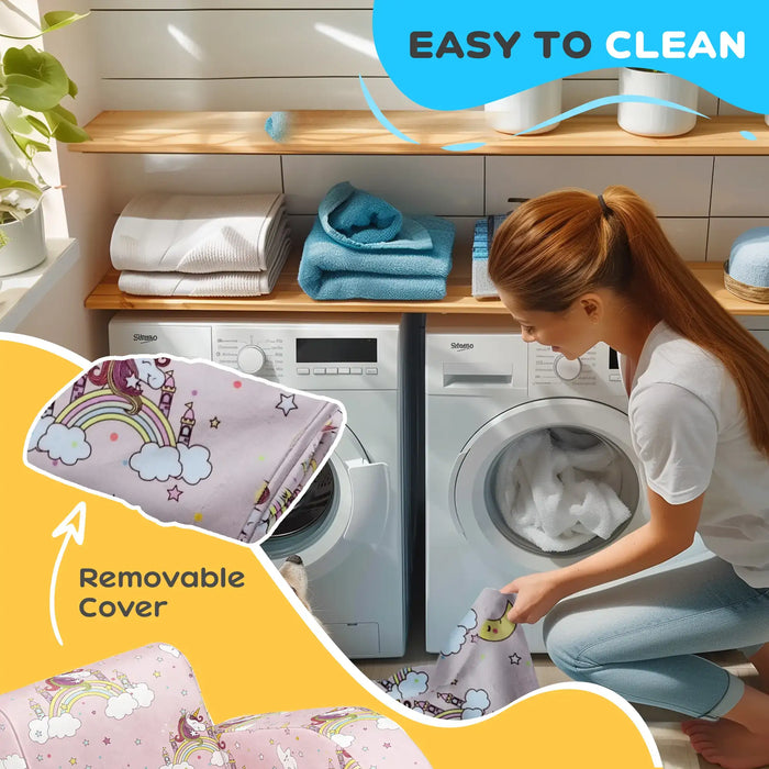 Woman loading washable unicorn and rainbow patterned blanket with removable cover into white washing machine in bright laundry room