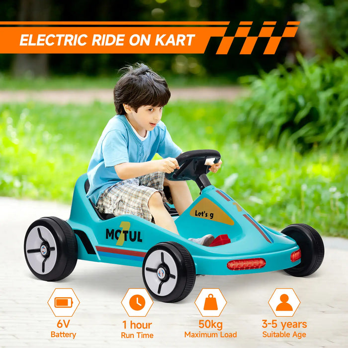 Child playing with a teal electric ride-on kart in an outdoor setting