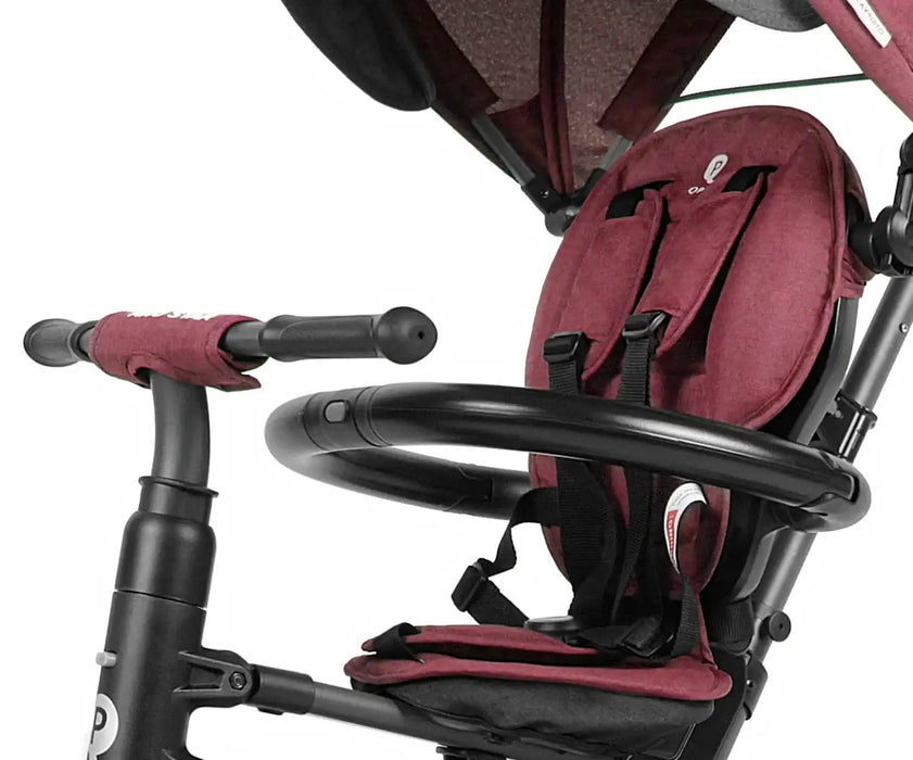 Red and black child seat attached to a stroller on a white background