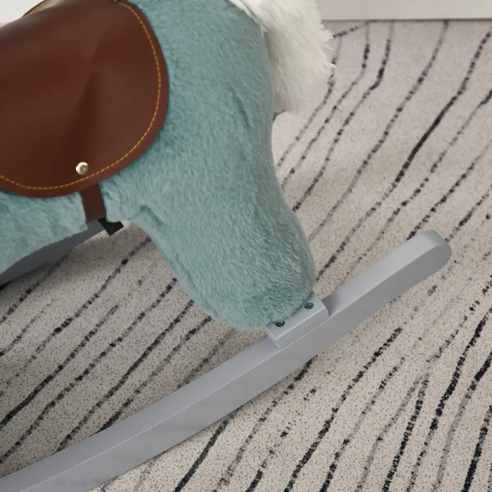 Blue plush rocking horse with brown saddle on striped carpet in kids room