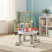 Baby activity center with toys on a round rug in a cozy living room with armchair and bookshelf