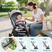 Woman and baby in a stroller with adjustable footrest feature, outdoors.