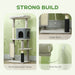 Gray multi-level cat tree with scratching posts, cozy hideaway, large base, and anti-tip kit in living room