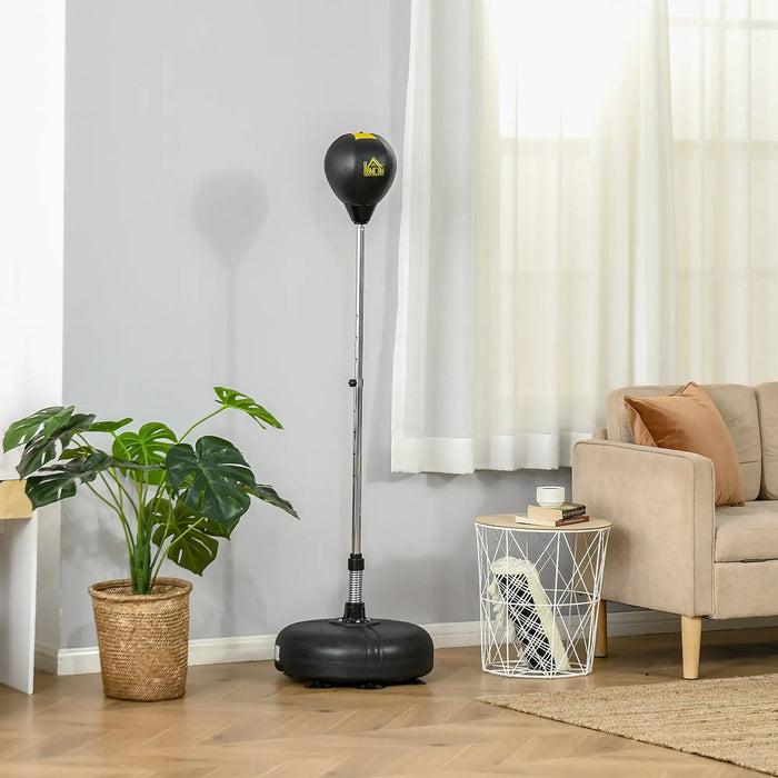 Freestanding black punching bag with adjustable stand in a bright living room with beige sofa and green potted plant
