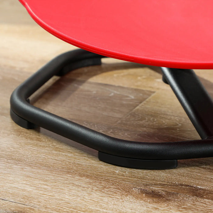 Close-up of a red chair seat and black metal frame on a wooden floor.