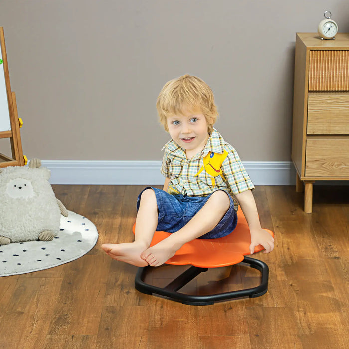 Child sitting on an orange balance chair in a room with wooden floor and furniture.
