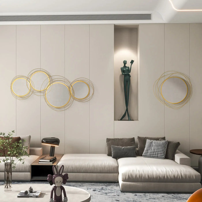 Modern living room with a stylish sofa, decorative wall art, and a small statue.