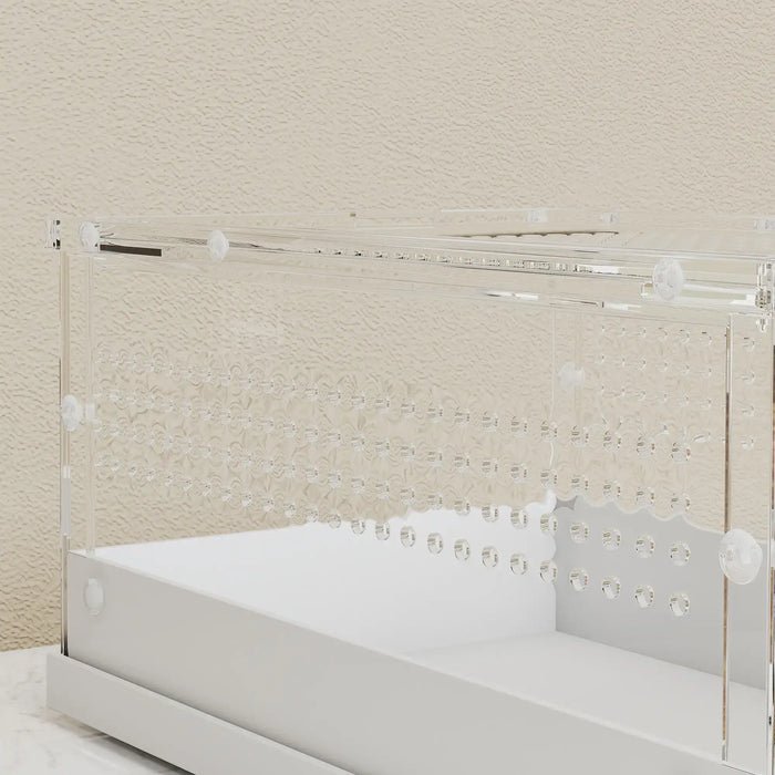 Transparent acrylic enclosure with ventilation holes on a white base against beige textured wall