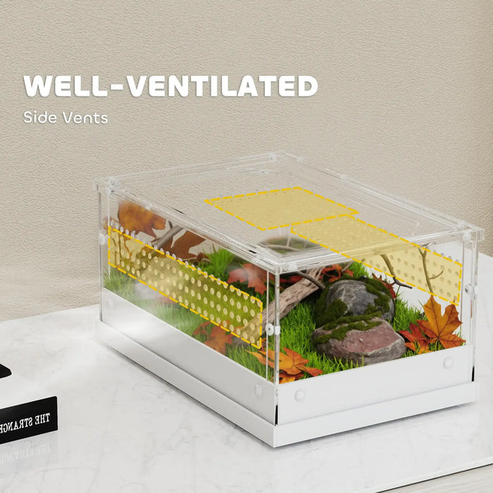 Transparent reptile enclosure with side vents, grass, rocks, and autumn leaves inside