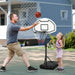 Adult and child playing with adjustable portable basketball hoop outdoors