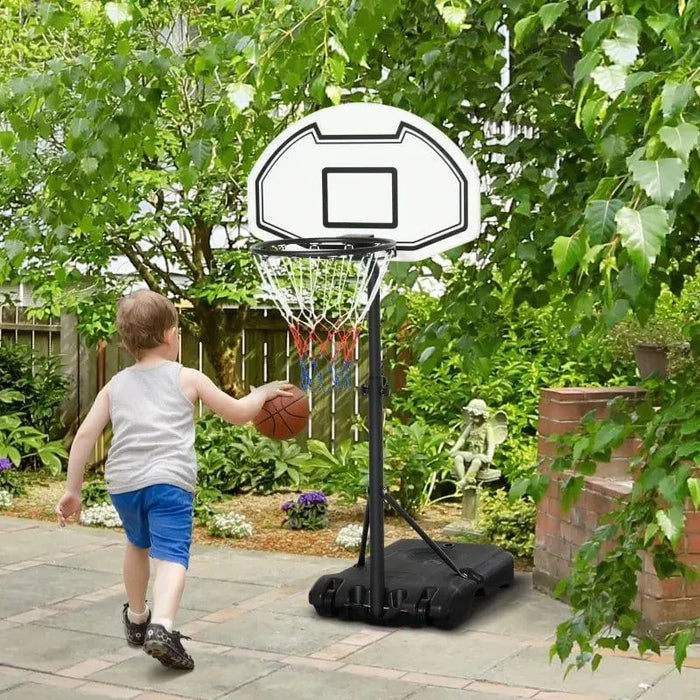 Child playing basketball with adjustable portable hoop in a garden patio