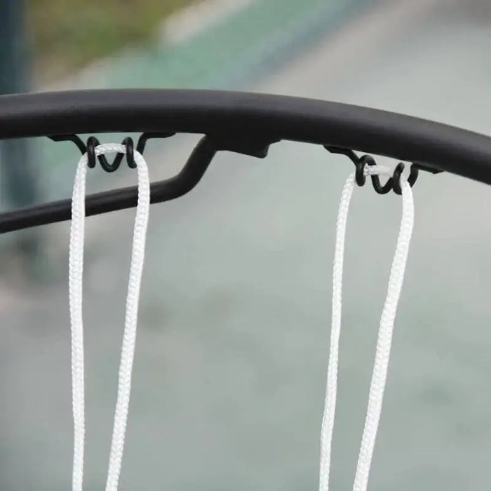 Close-up of portable basketball hoop rim with white nylon net outdoors