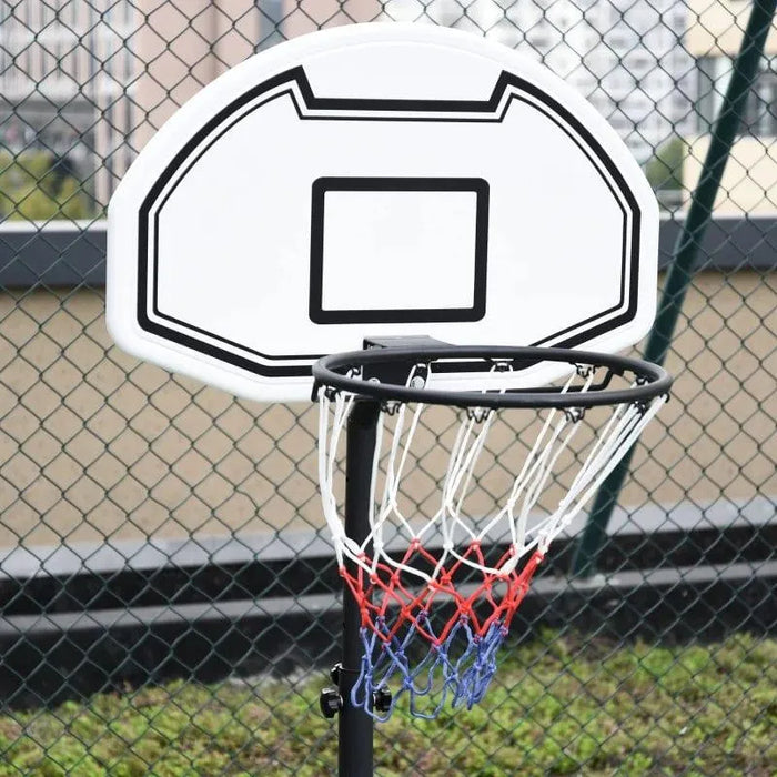 Adjustable portable basketball hoop with nylon net on outdoor court near chain-link fence