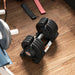 Pair of adjustable dumbbells on a wooden floor with gym equipment in the background.